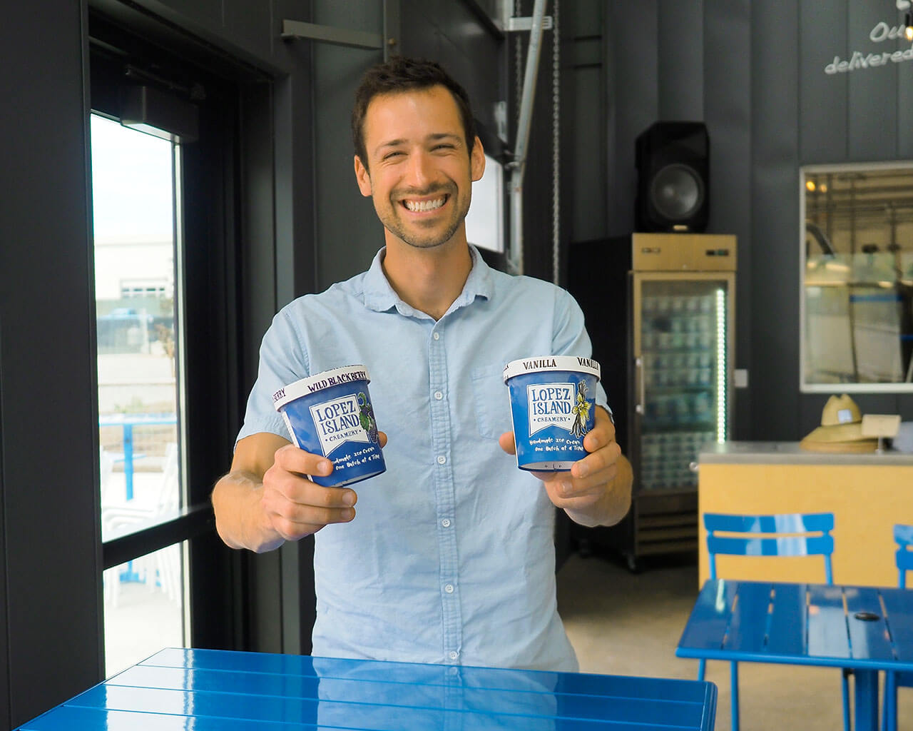 Man holding pints of Lopez Island ice cream